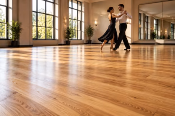 Couple dancing on a professionally sanded wooden floor in a bright and elegant modern dance studio.